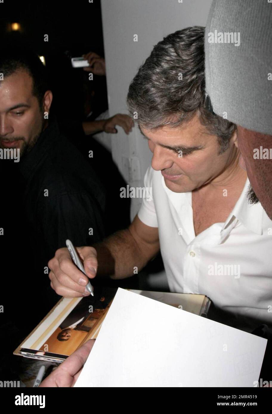 Actor George Clooney signs some night-time autographs before hitting ...