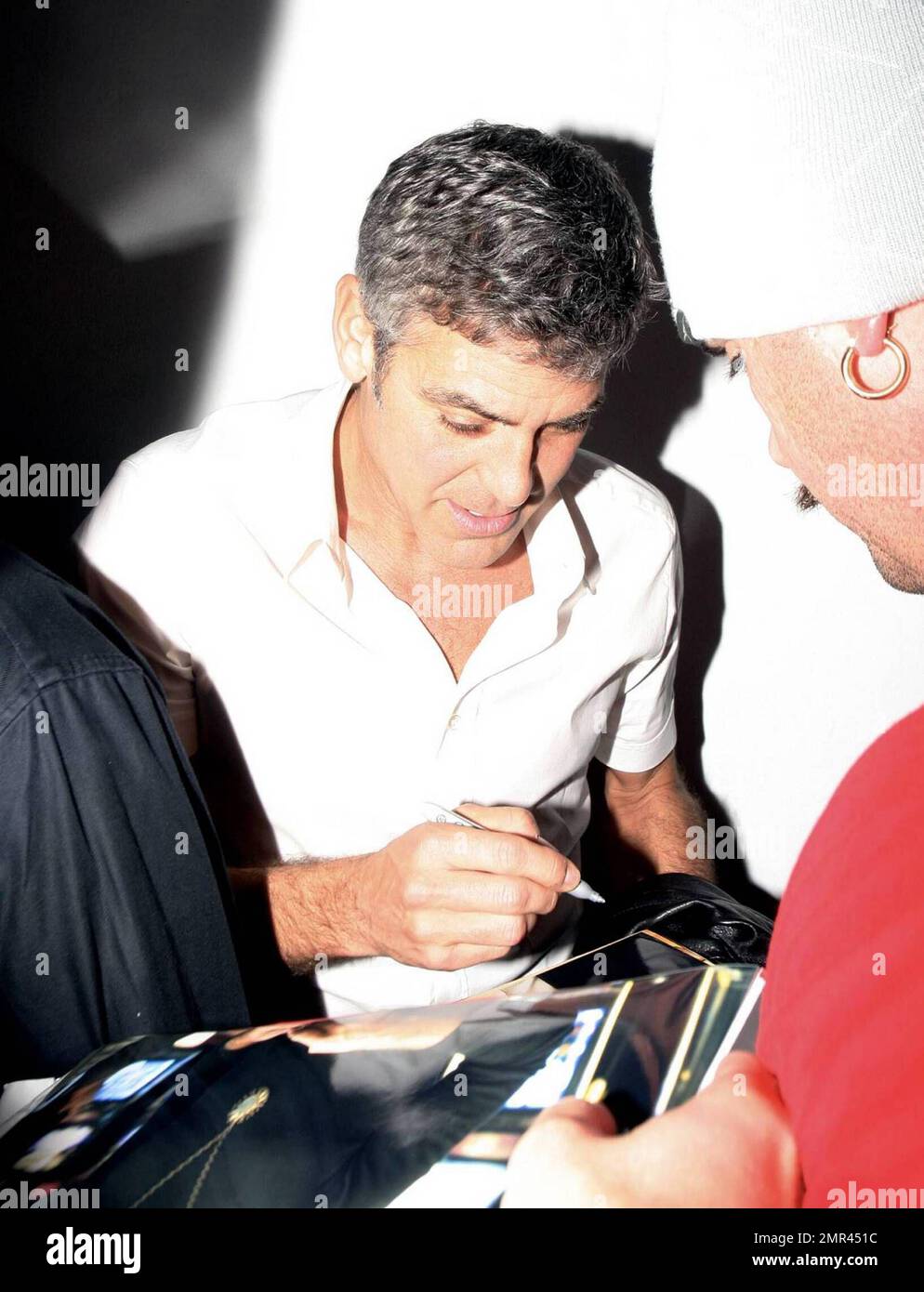 Actor George Clooney signs some night-time autographs before hitting ...