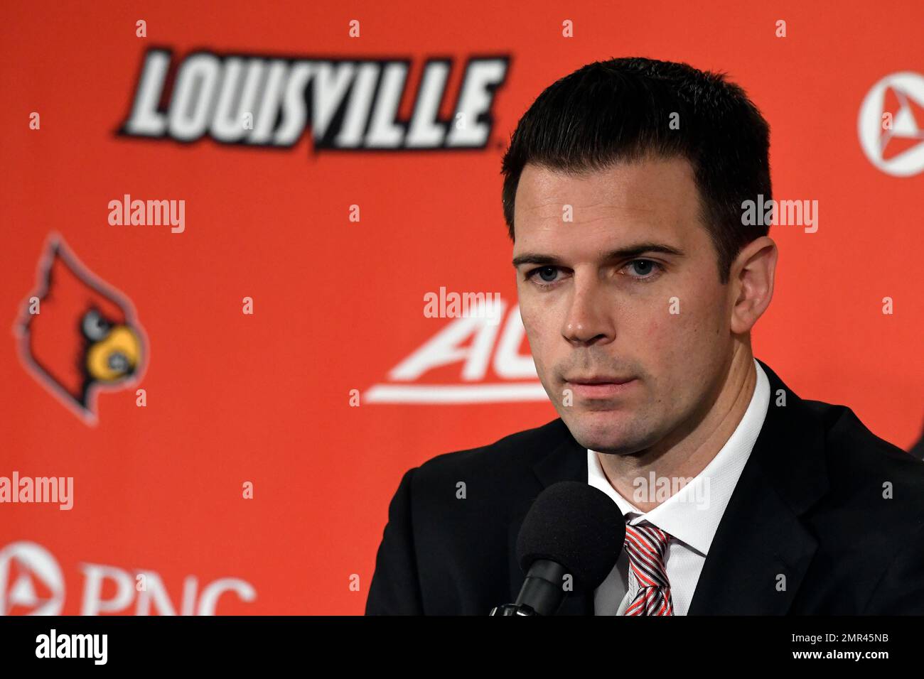 Louisville acting head coach David Padgett listens to a reporters' question during an NCAA