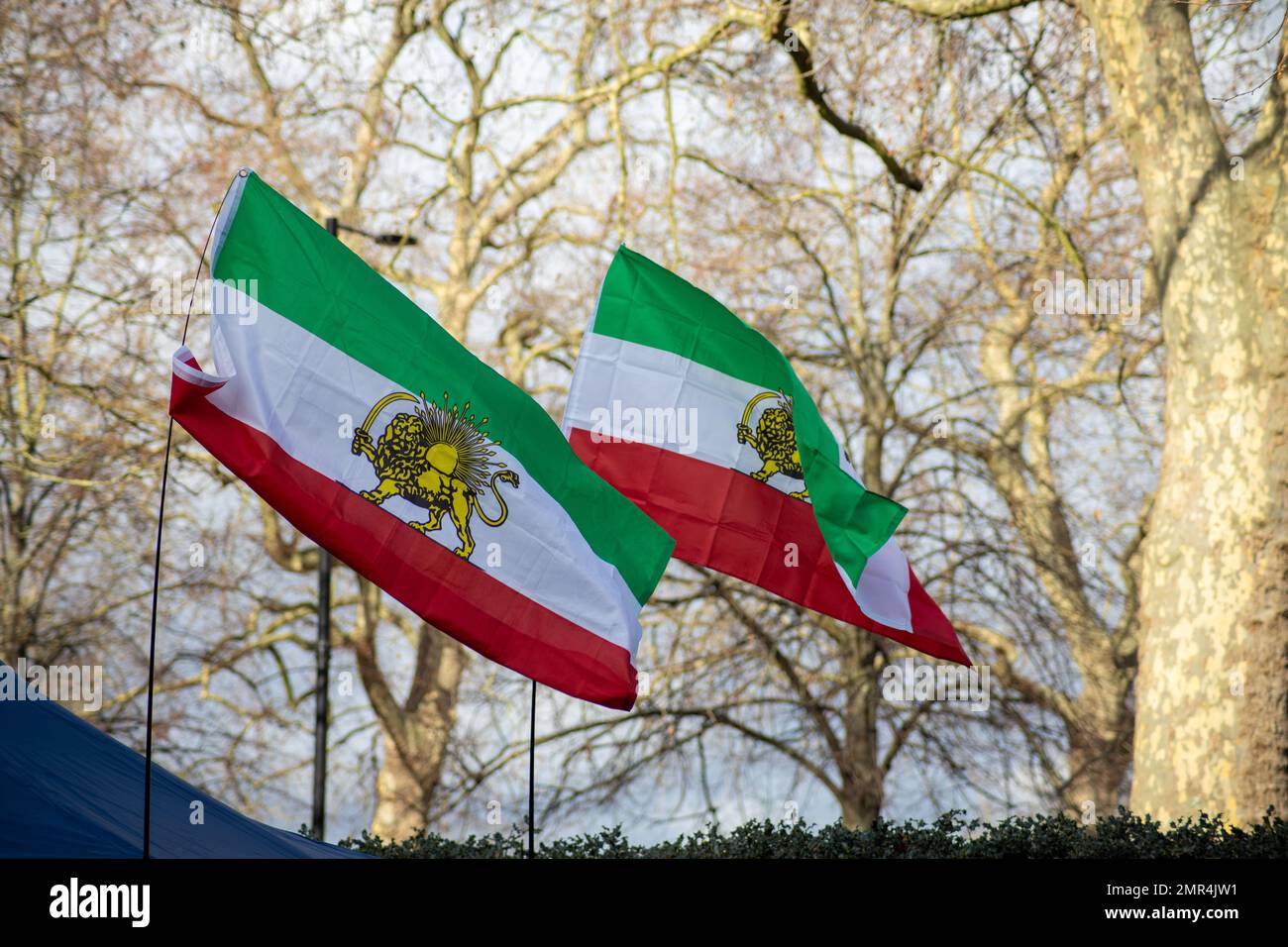 London, UK – 31 Jan. 2023: Iranian Pre-revolution (1979) flag—known as Shir-o-Khorshid flag—flying in front of Islamic Republic of Iran’s Embassy as protesters are chanting slogans against the Islamic Regime of Iran. Credit: Sinai Noor/Alamy Live News Stock Photo