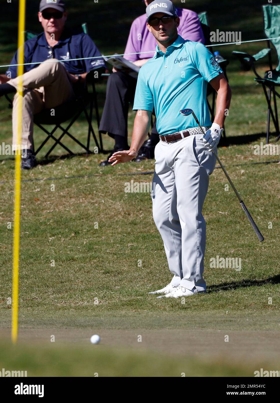Andrew Landry gestures after a chip shot towards the 18th hole during