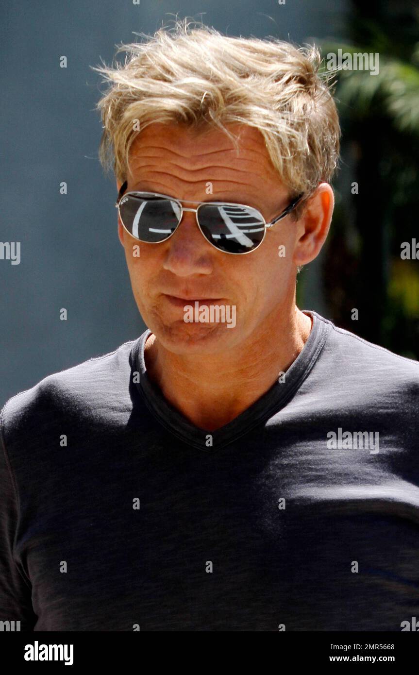 Celebrity chef Gordon Ramsey goes casual in a black t shirt tan shorts and flip flops paired with some aviator sunglasses as he spends an afternoon at The Grove. Los Angeles CA