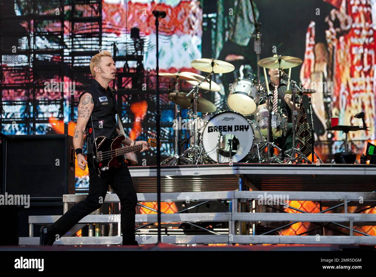 Mike Dirnt and drummer TrŽ Cool of the punk rock band Green Day perform live at Wembley Stadium. The group, who formed in 1987, played the 90000 capacity stadium with Joan Jett and Frank Turner as the opening act.  The Wembley show is just one of many that the trio will play as part of their world summer tour, which will see them perform in Europe, North and South America.  Green Day has sold more than 50 million albums worldwide and have recently become the subject of the successful video game Rock Band. London, UK. 06/19/10. Stock Photo