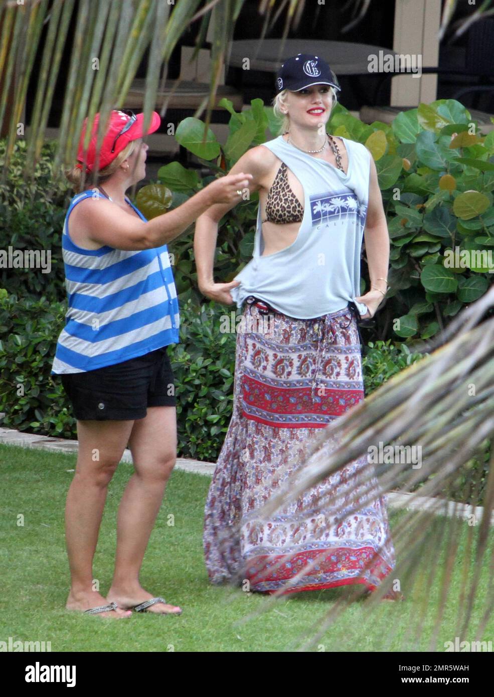 Gwen Stefani and husband Gavin Rossdale take a trip to the beach following an outing to a science museum with their two sons Kingston and Zuma. Gwen kept on a wrap and t-shirt but revealed an animal print bikini underneath. Despite rumors of marital problems, the couple shared a tender moment on th beach where they gazed lovingly into each other's eyes. A fellow hotel guest commented that the couple appeared sot;; 'very much in love' and that 'Gavin looks like a fantastic dad'. They added that Gwen was 'absolutely beautiful in person'. After sunset the couple took a dip in the hot tub and sipp Stock Photo
