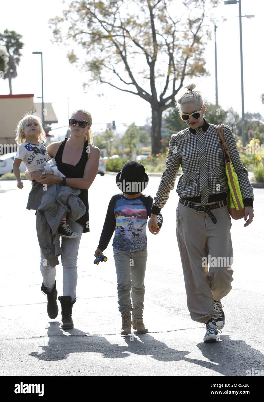 'No Doubt' singer and fashion designer Gwen Stefani takes her sons, 6 year old Kingston and 4 year old Zuma for a family day out at Underwood Family Farms in L.A. 42 year old Gwen wore a tan plaid jacket with baggy tan pants and topped off with a black hat, black sneakers and sunglasses as she is seen carrying three boxes of strawberries she purchased at the farm. Kingston is seen enjoying a pony ride and riding a giant tricycle. Los Angeles, CA. 26th May 2012. Stock Photo