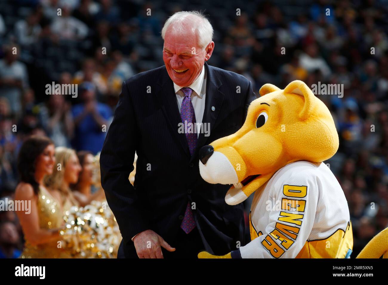 Retired Denver Nuggets center Dan Issel, left, his welcomed by team mascot Rocky the mountain lion during the team's 50th anniversary celebration before the second half of an NBA basketball game Saturday, Oct. 21, 2017, in Denver. The Nuggets won 96-79. (AP Photo/David Zalubowski) Stock Photo