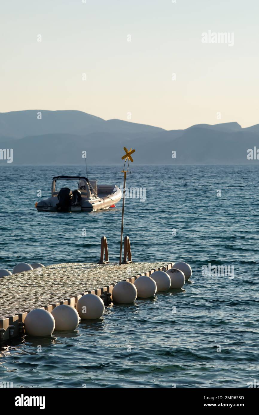 Ios, Greece - June 3 , 2021 : View of a floating dock and a speed boat ...
