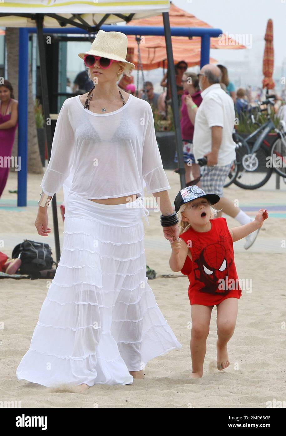 Singer and fashion designer Gwen Stefani is seen taking her son Zuma to  play at a water fountain in Santa Monica Beach. Gwen hid her amazing body  under a see-through white top