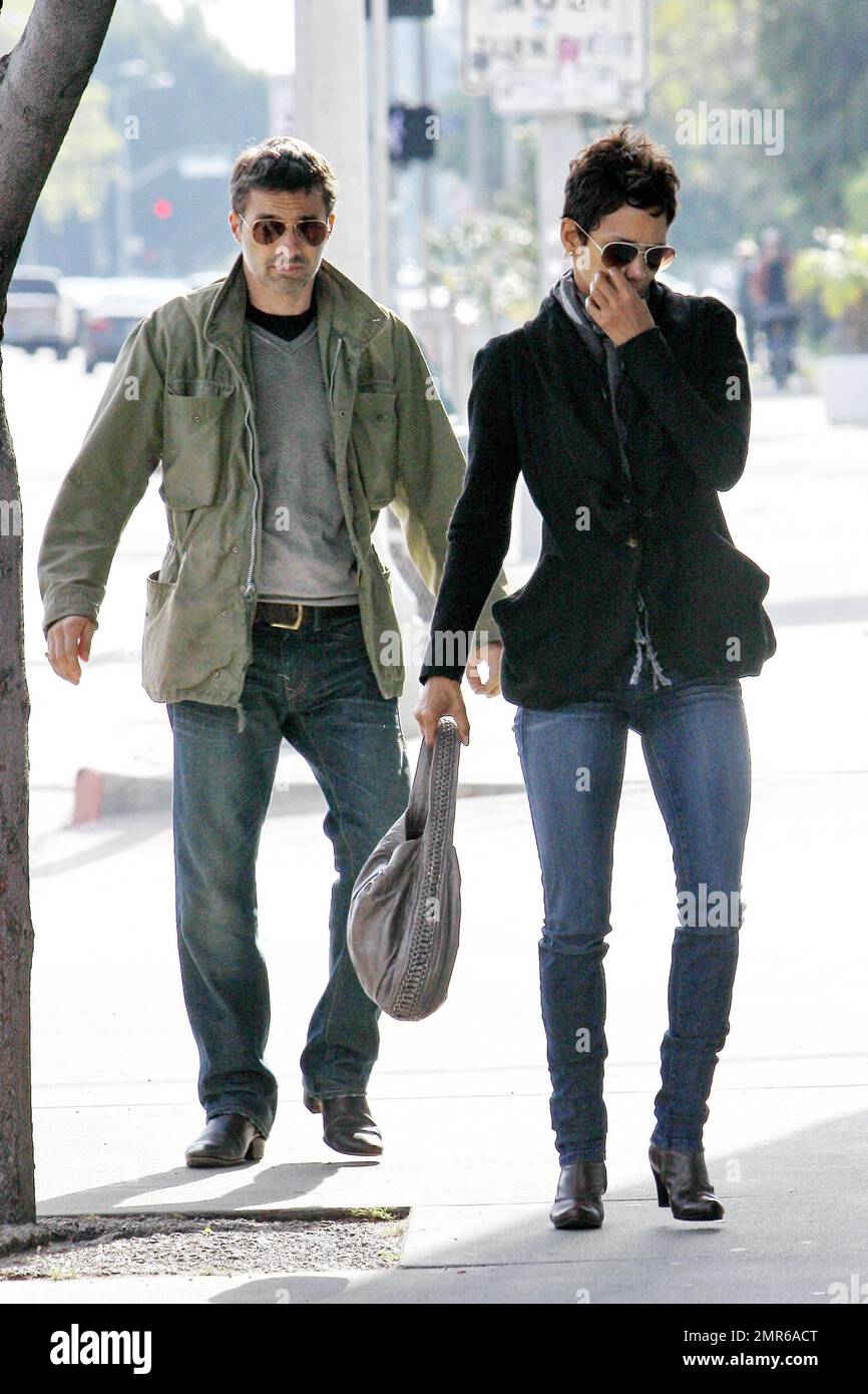 In a nice black ruffled jacket and jeans Halle Berry holds hands with  boyfriend Olivier Martinez, who looked hunky in a casual green jacket, grey  shirt and jeans, as they arrive for