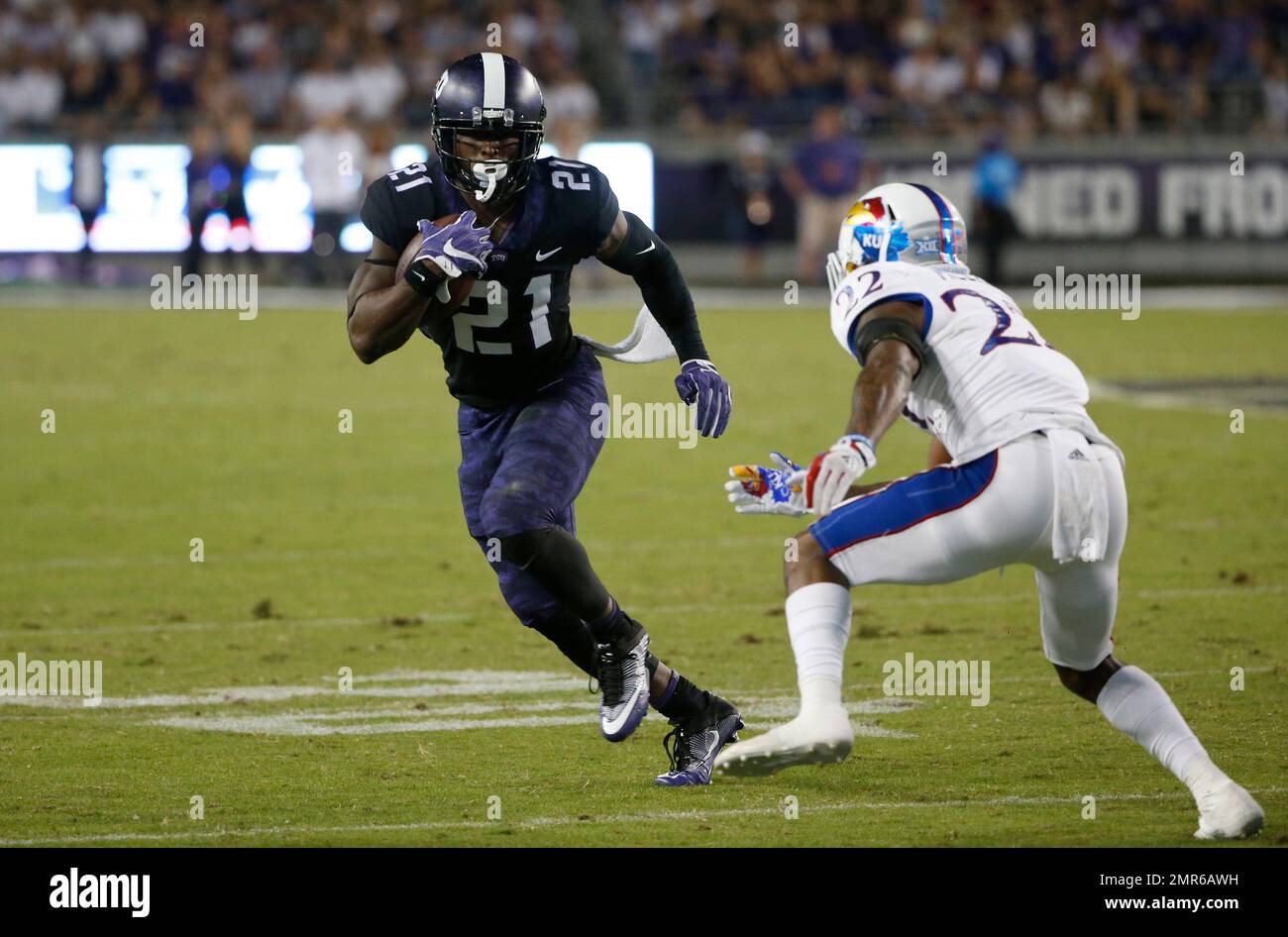 TCU running back Kyle Hicks (21) tries to run past Kansas safety Tyrone