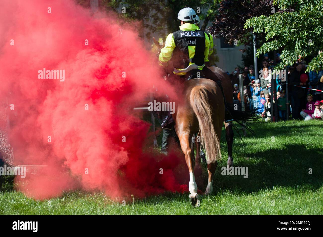PEZINOK, SLOVAKIA - MAY 4, 2014: Demonstration of mounted police horses walking through the smoke in Pezinok, Slovakia Stock Photo