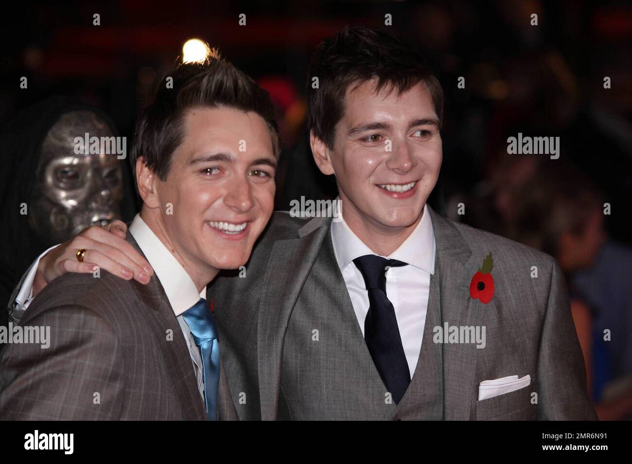 James Phelps and Oliver Phelps pose on the red carpet at the world
