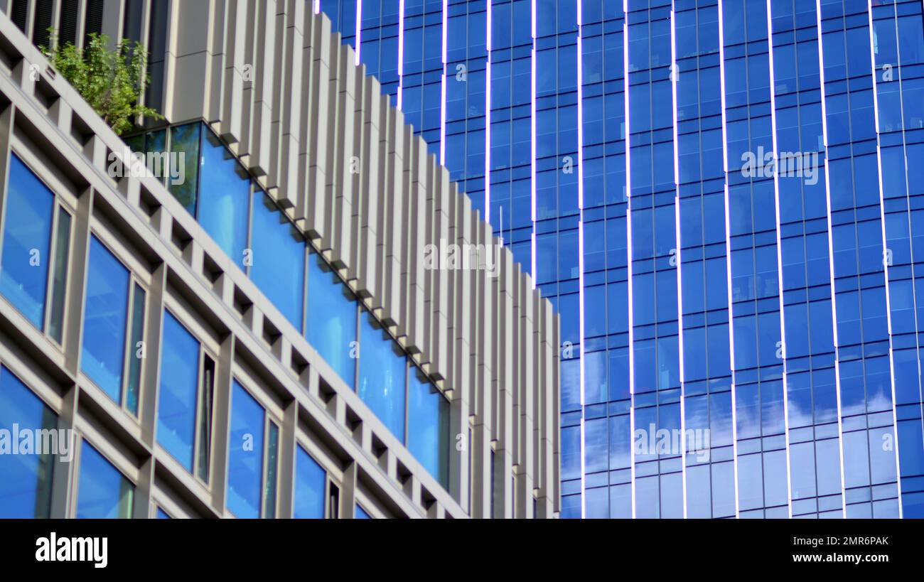 Abstract closeup of the glass-clad facade of a modern building covered ...