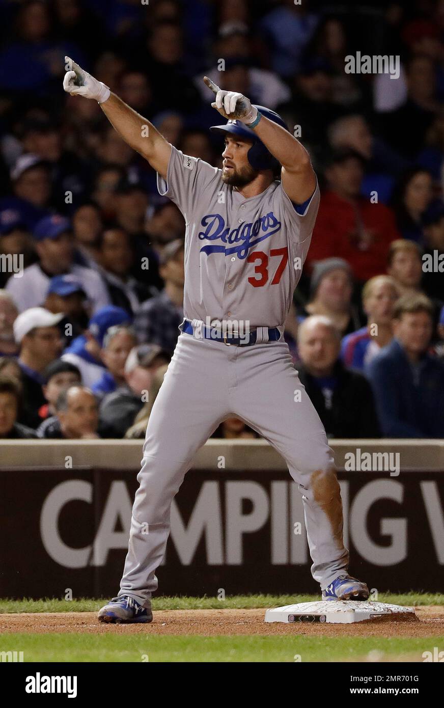 Los Angeles Dodgers' Charlie Culberson (37) reacts after hitting a triple  off Chicago Cubs relief pitcher Mike Montgomery during the eighth inning of  Game 5 of baseball's National League Championship Series, Thursday,