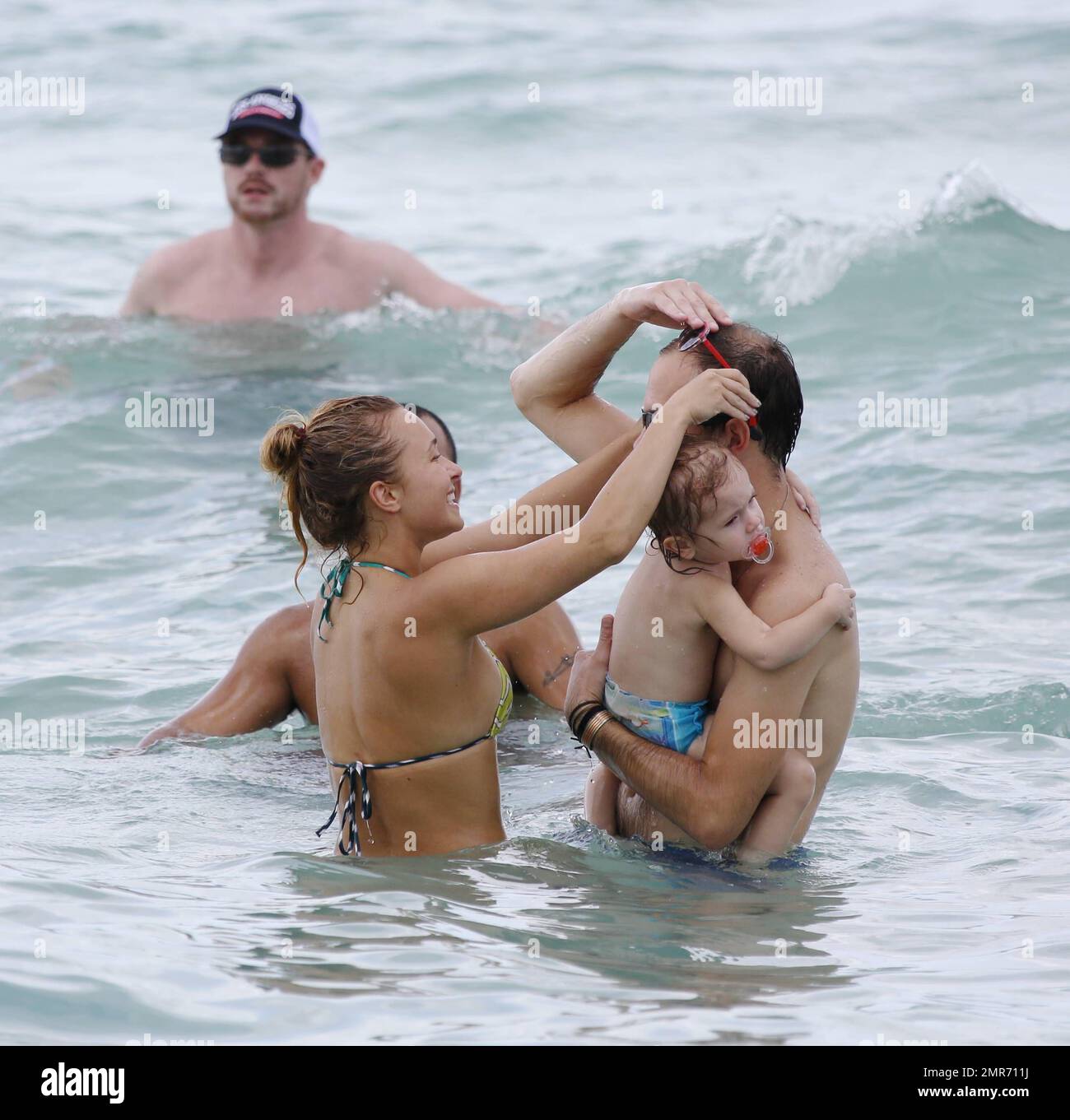 Hayden Panettiere spends Labour Day weekend with friends wearing a colorful bikini and taking a dip in the ocean near her fiancé's beach home. Hayden splashed one over zealous photographer who actually swam up to her in the ocean with his video camera. After drinking a few cocktails and beer, the petite actress swam back along the shore to her condo. Hollywood Beach, FL. 1st September 2013 . Stock Photo