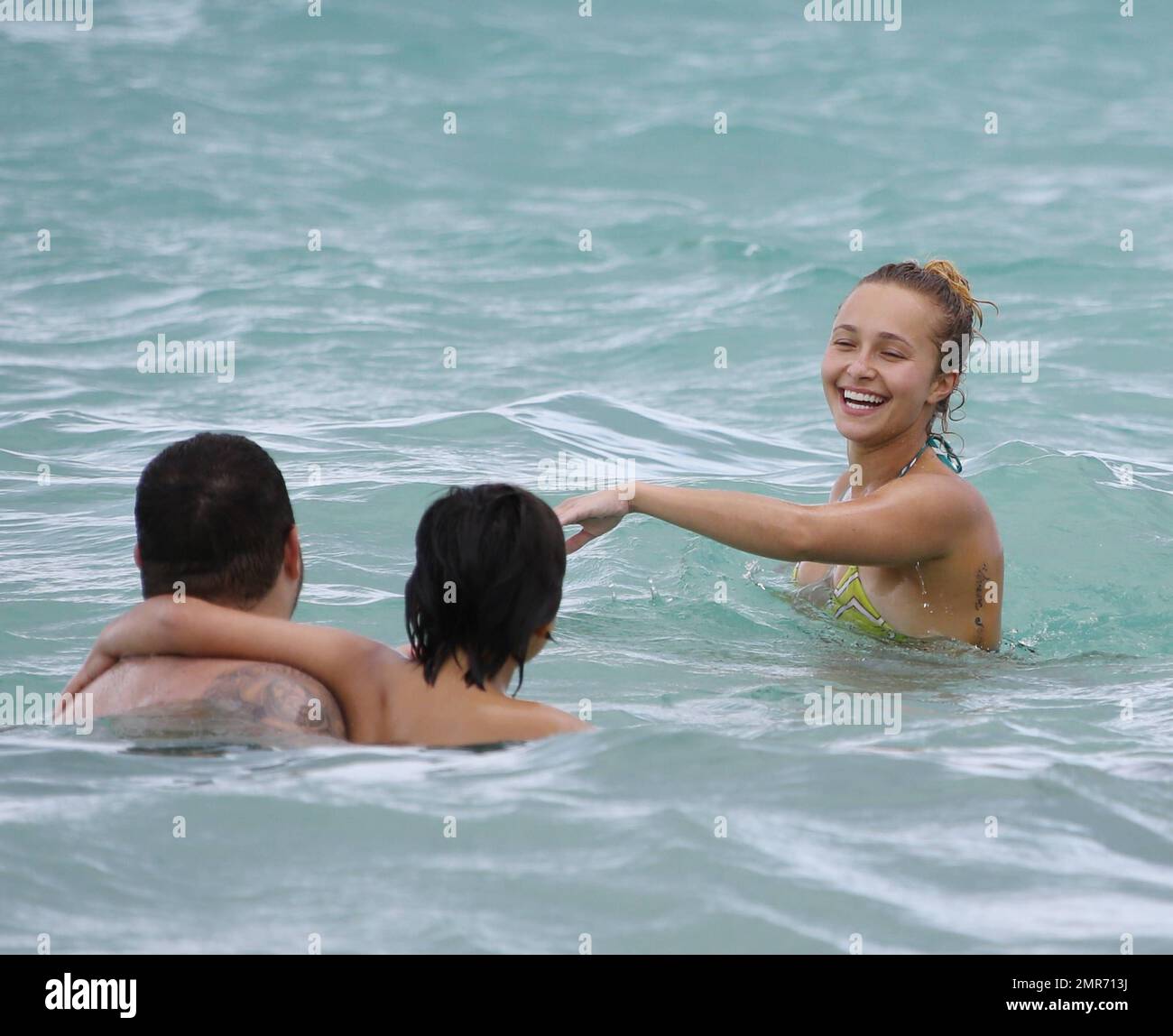 Hayden Panettiere spends Labour Day weekend with friends wearing a colorful bikini and taking a dip in the ocean near her fiancé's beach home. Hayden splashed one over zealous photographer who actually swam up to her in the ocean with his video camera. After drinking a few cocktails and beer, the petite actress swam back along the shore to her condo. Hollywood Beach, FL. 1st September 2013 . Stock Photo