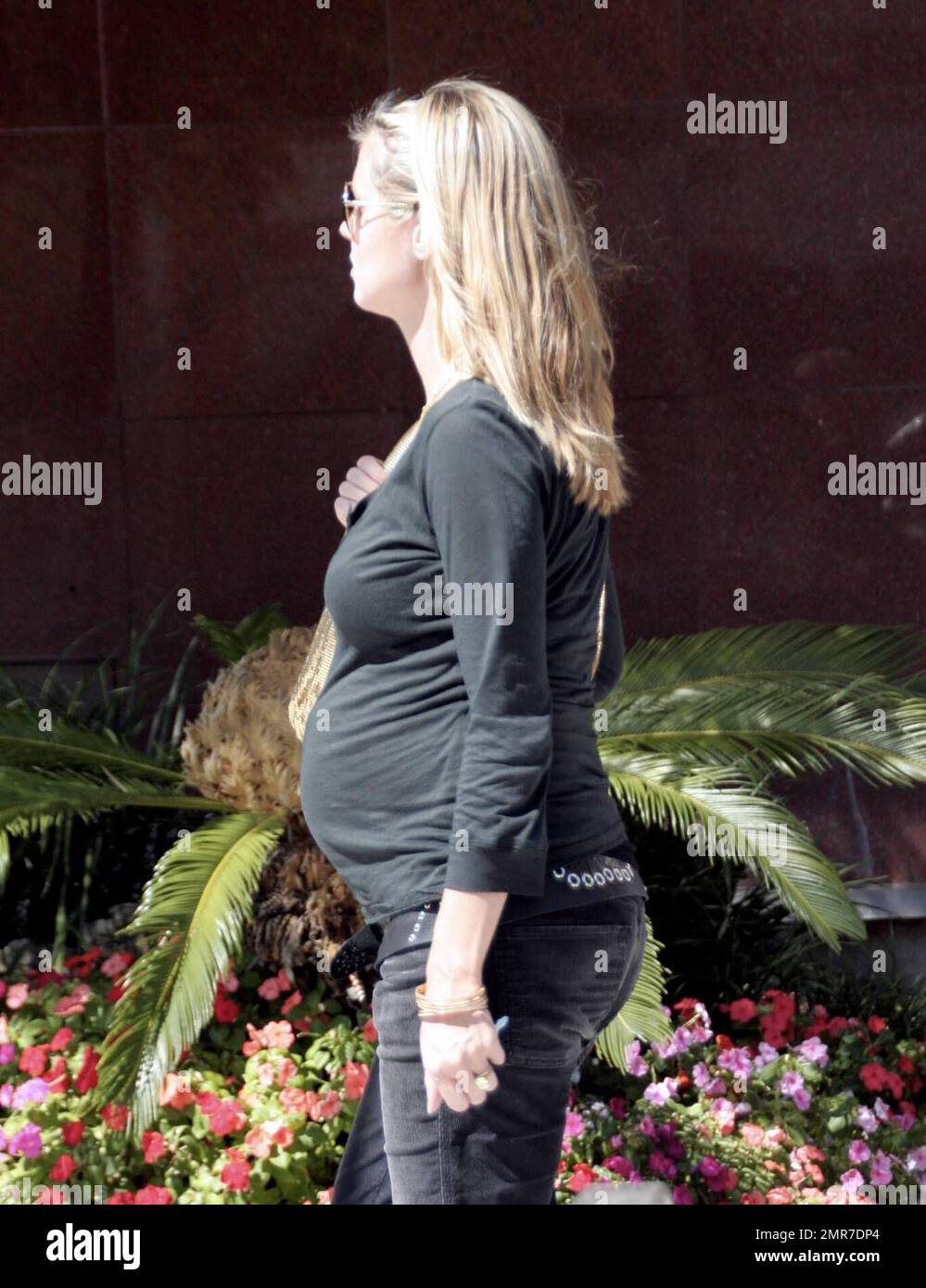 A pregnant Heidi Klum flaunts her bump in a tight fitting top and wears