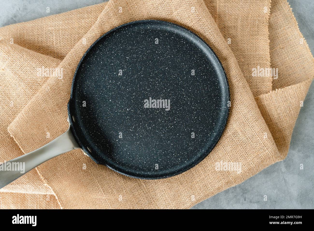 Black frying pan or skillet close-up on a rustic background, flat lay with copy space Stock Photo