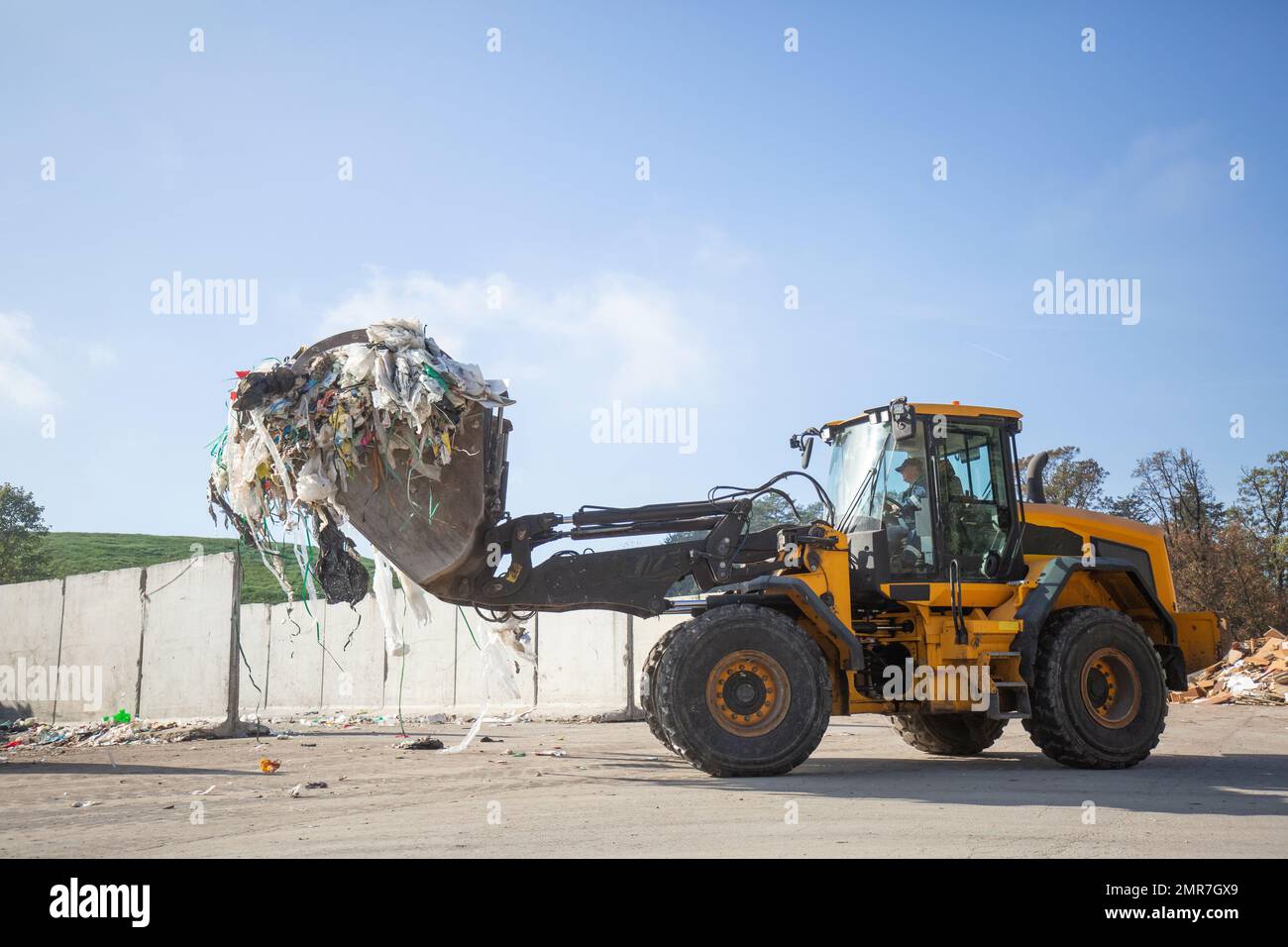 Heavy construction machine, front end loader moving along recycling