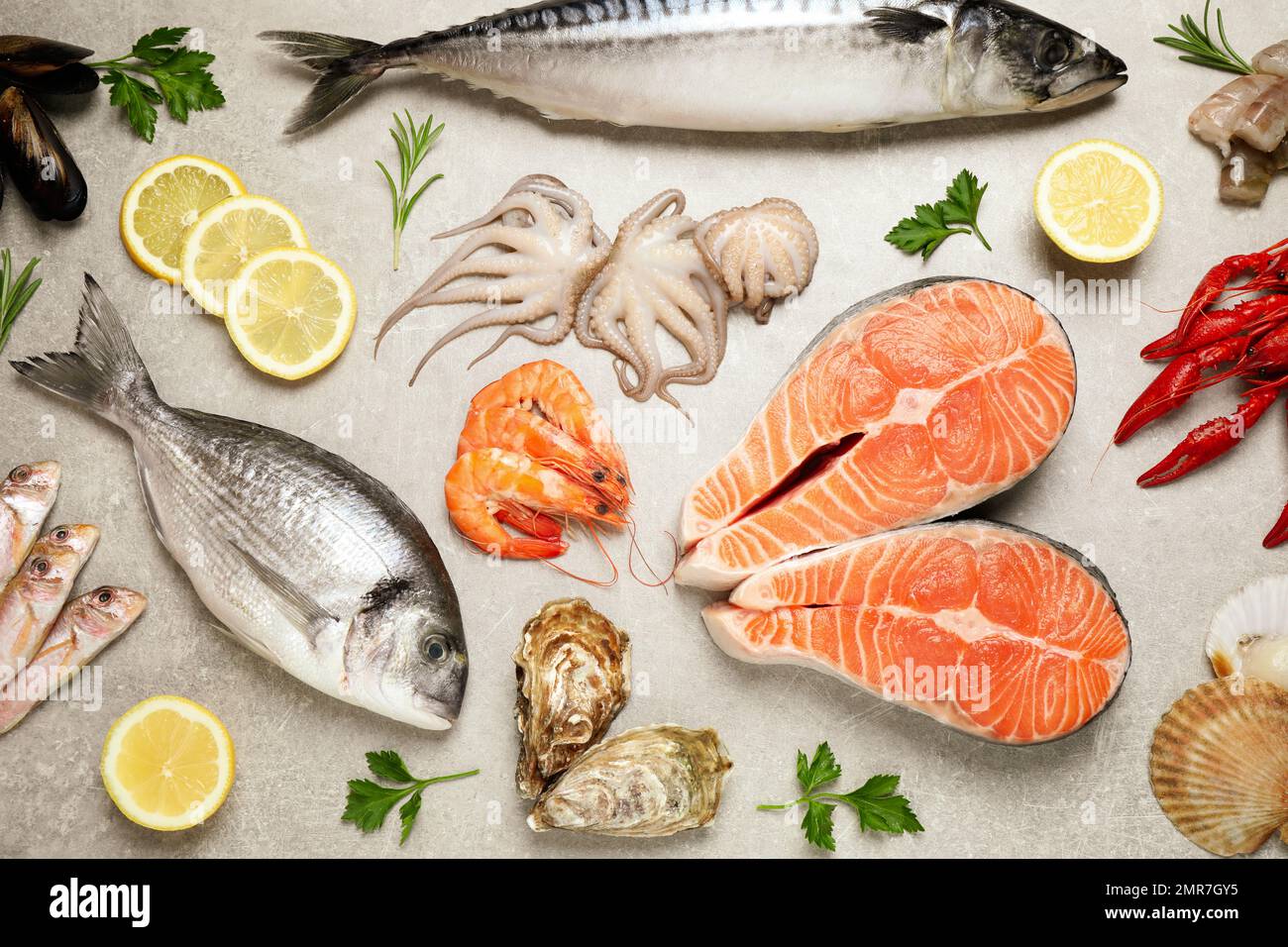 Fresh fish and seafood on light grey table, flat lay Stock Photo - Alamy