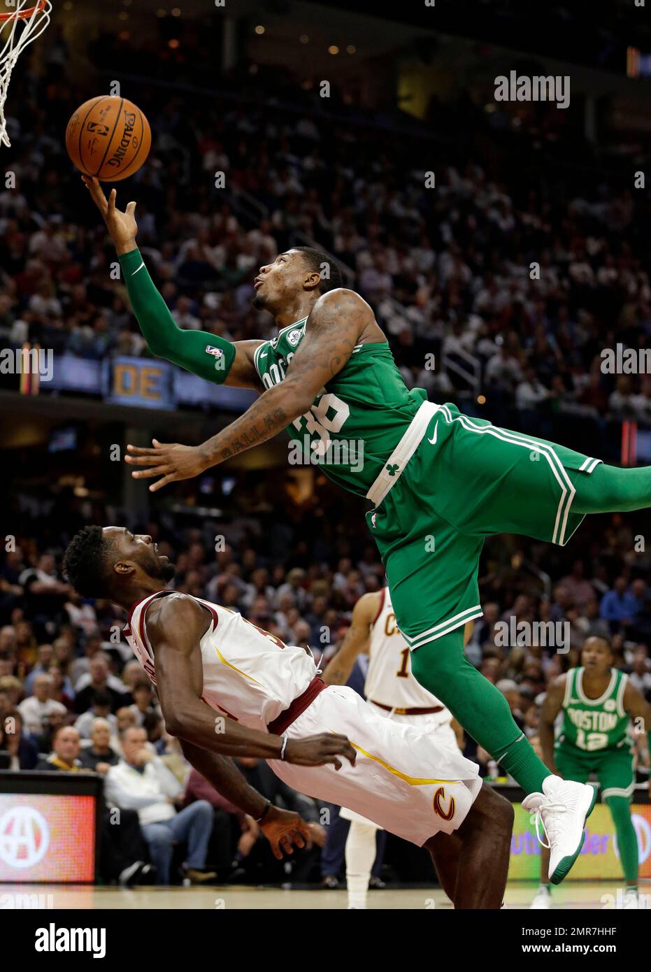 Boston Celtics' Marcus Smart, top, fouls Cleveland Cavaliers' Jeff