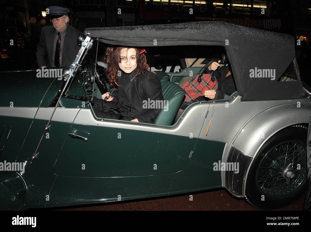 Actress Helena Bonham Carter dons a black dress, black ruffled jacket