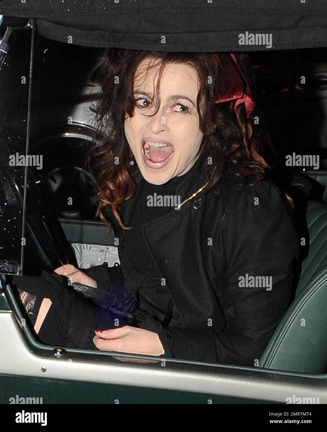 Actress Helena Bonham Carter dons a black dress, black ruffled jacket and a  red ribbon in her hair to switch on the Christmas lights at Burlington  Arcade. Carter arrived at the event
