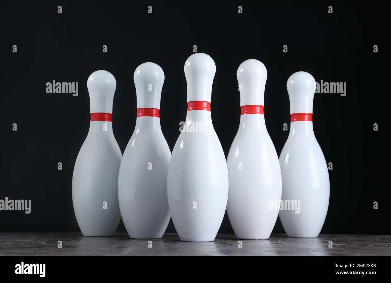 Set of bowling pins on grey stone table Stock Photo Alamy