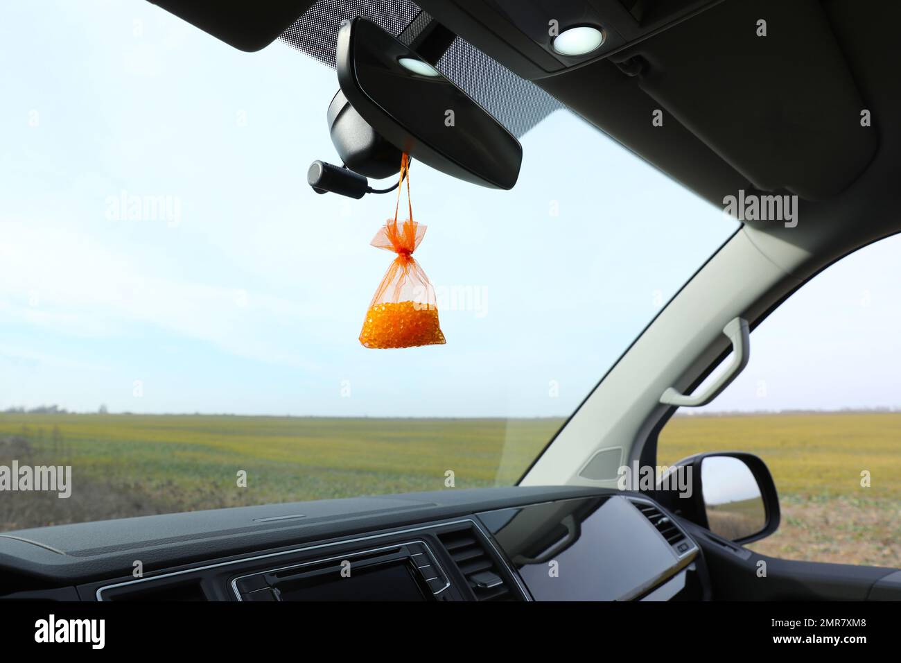 Air freshener hanging on rear view mirror in car Stock Photo Alamy