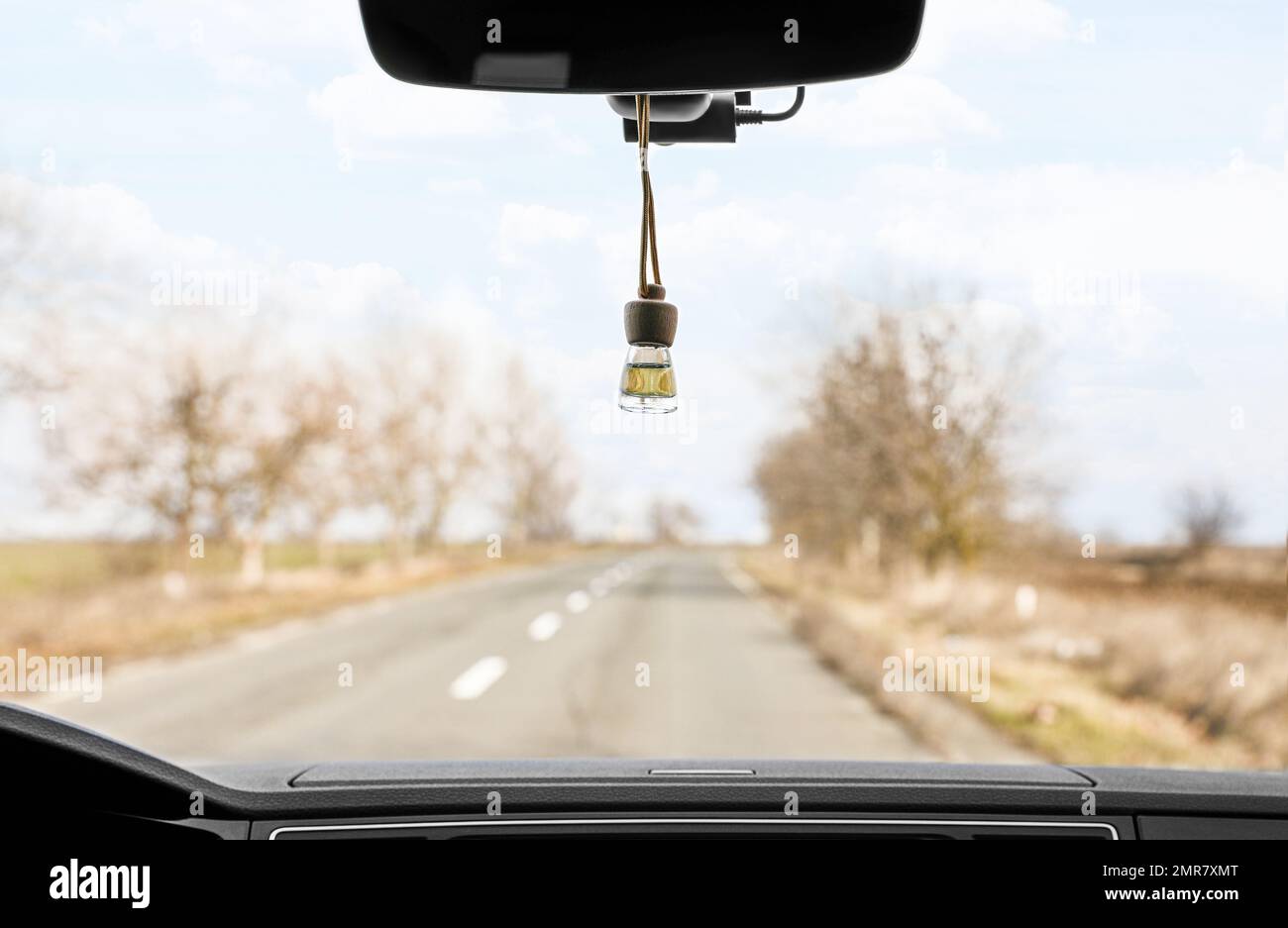 Air freshener hanging on rear view mirror in car Stock Photo Alamy