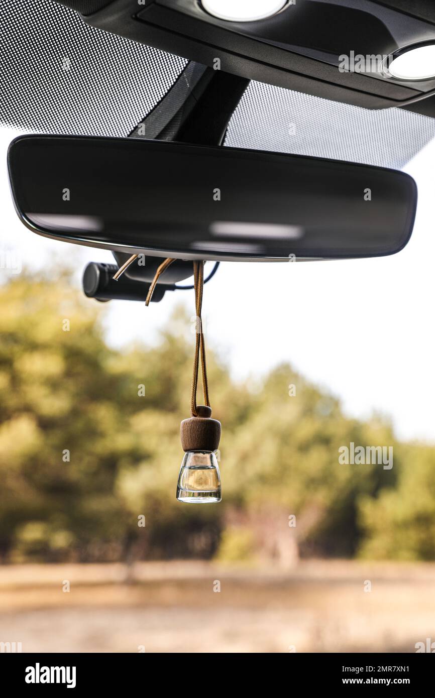 Air freshener hanging on rear view mirror in car Stock Photo Alamy