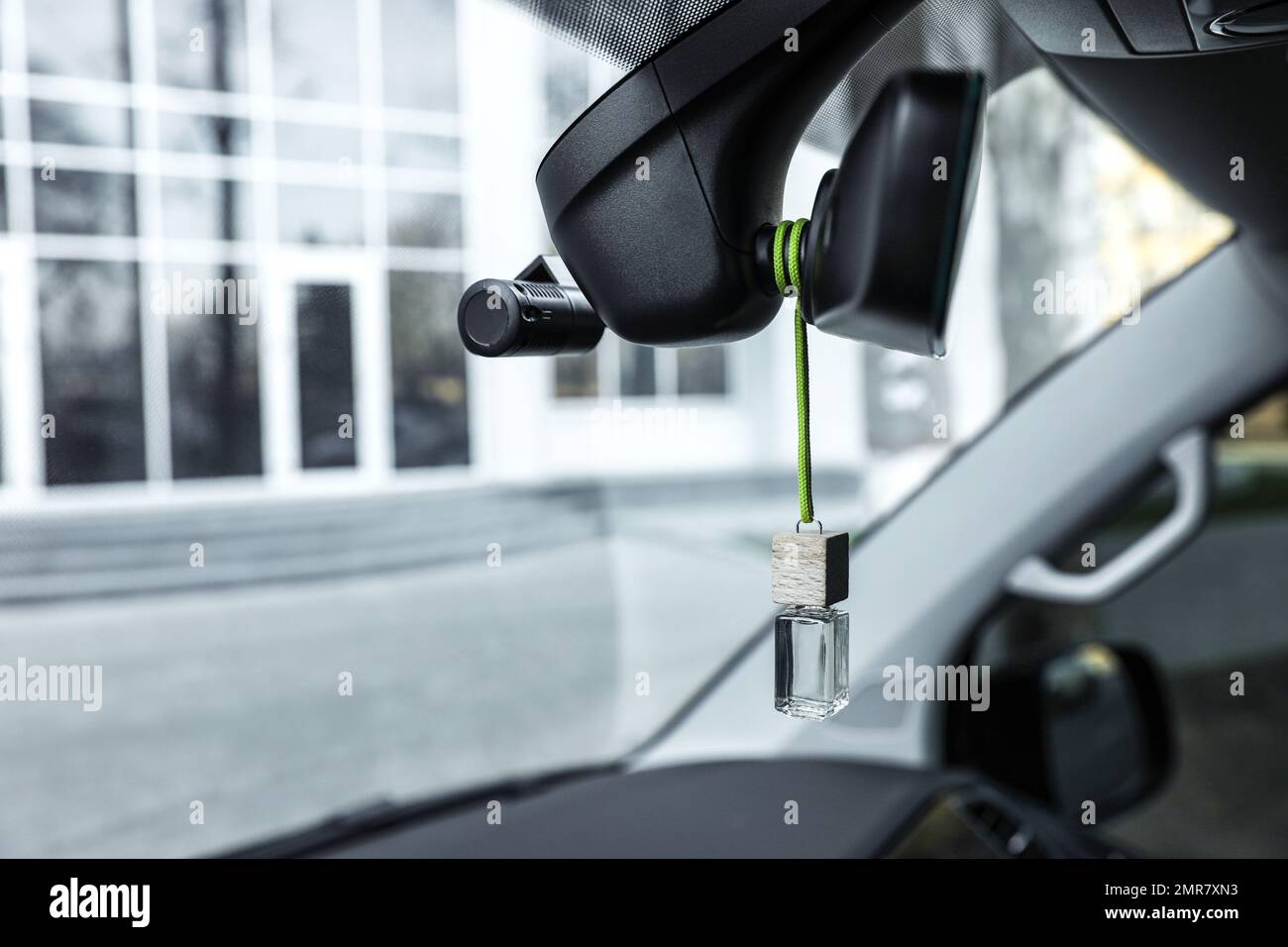 Air freshener hanging on rear view mirror in car Stock Photo Alamy