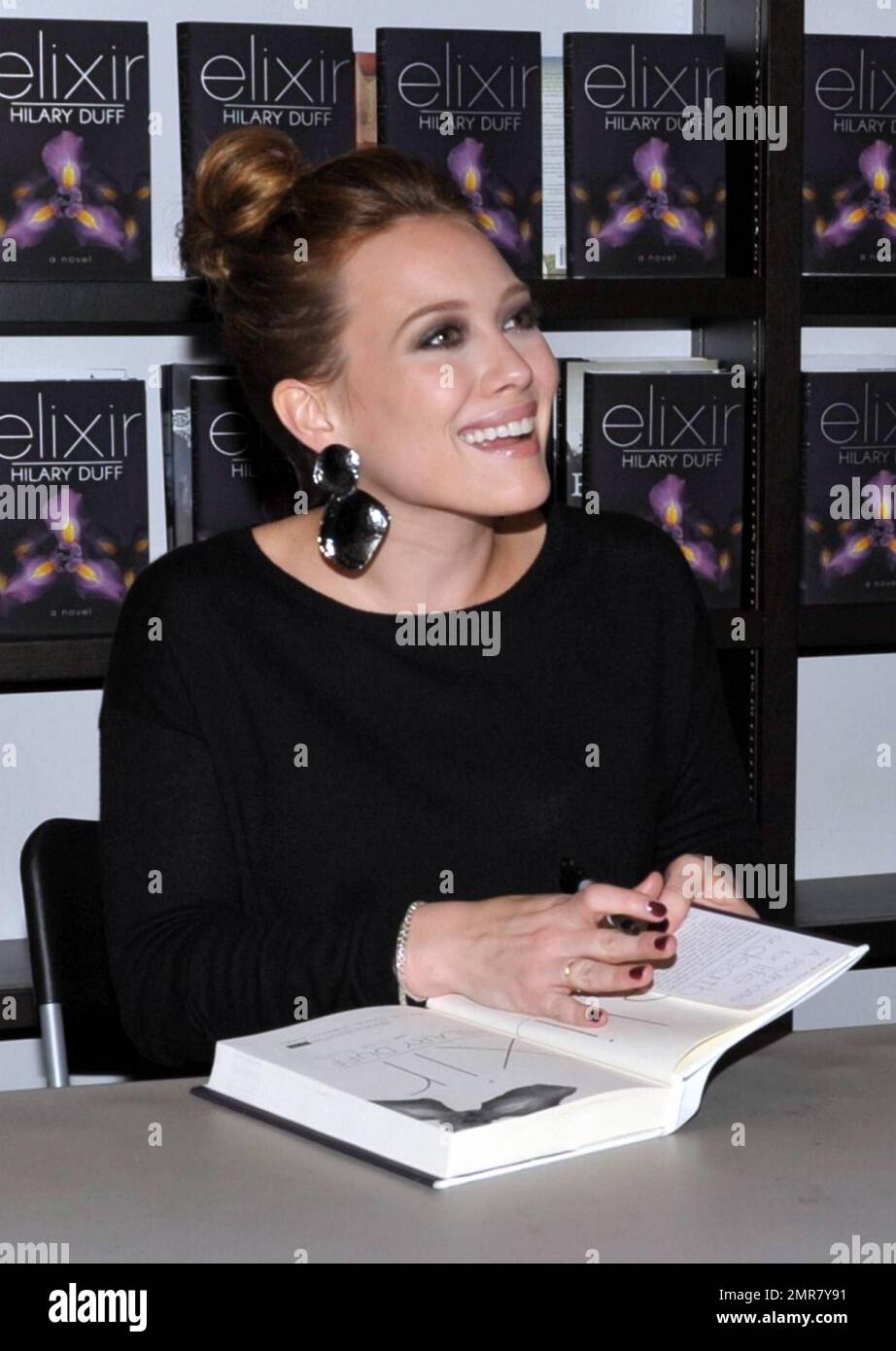 Wearing a black top and camouflage patterned leather pants, actress Hilary Duff delights a huge crowd of fans by signing copies of her new book "Elixir" at Books & Books in the Bal Harbor Shops in Bal Harbor, FL. 10/15/10. Stock Photo