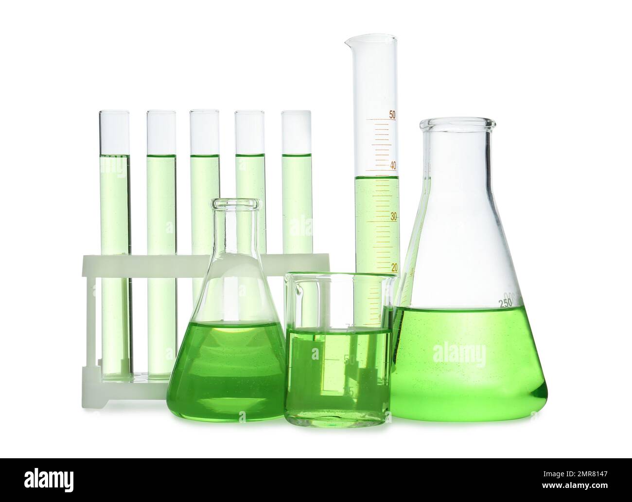 Different laboratory glassware with light green liquid isolated on ...