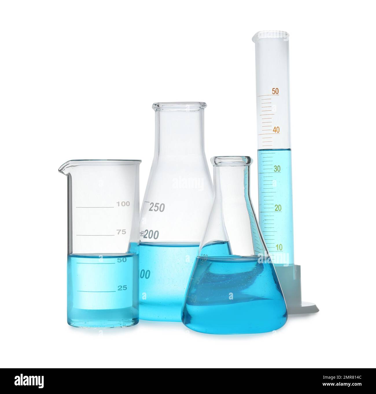 Different laboratory glassware with light blue liquid isolated on white