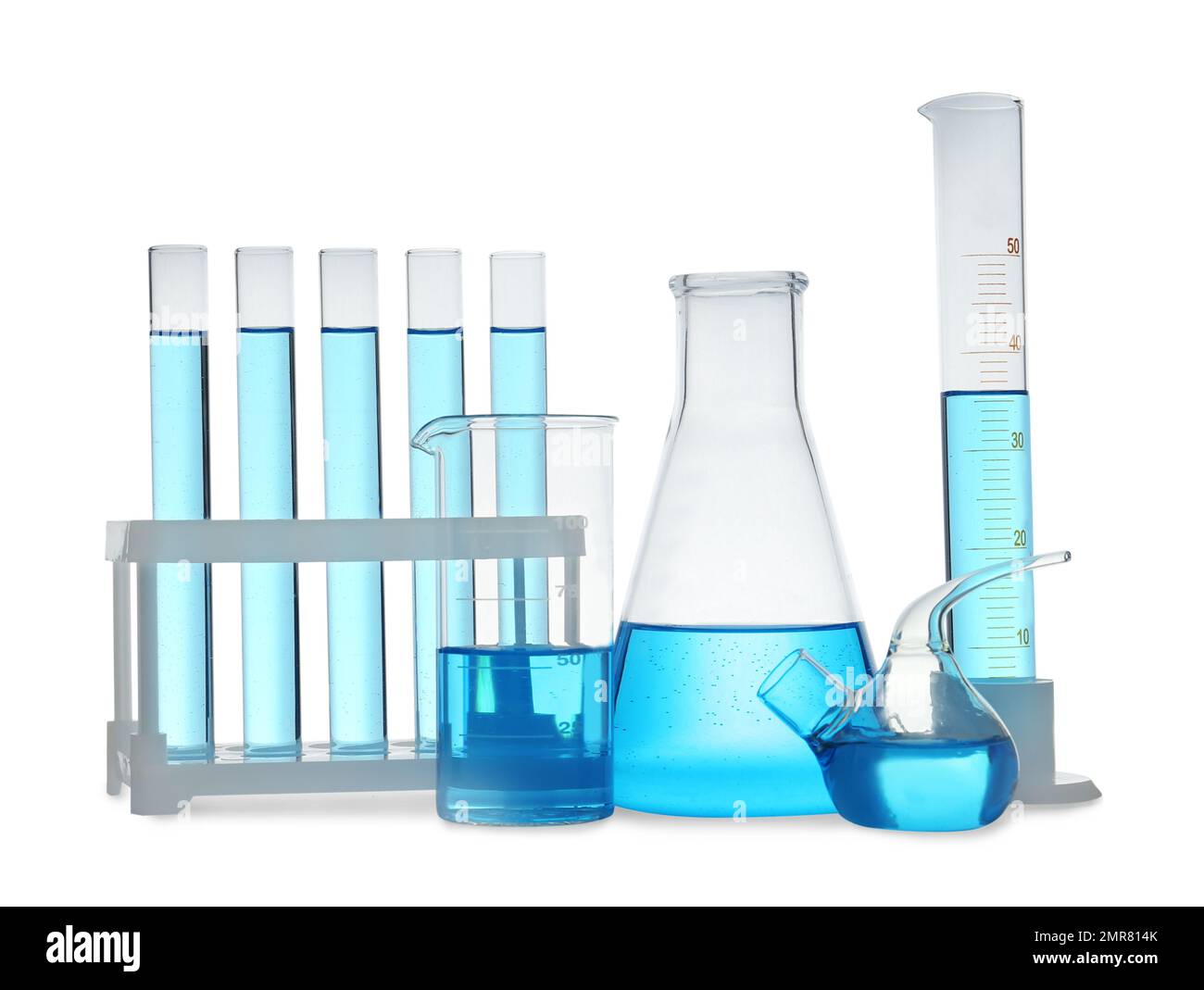 Different laboratory glassware with light blue liquid isolated on white
