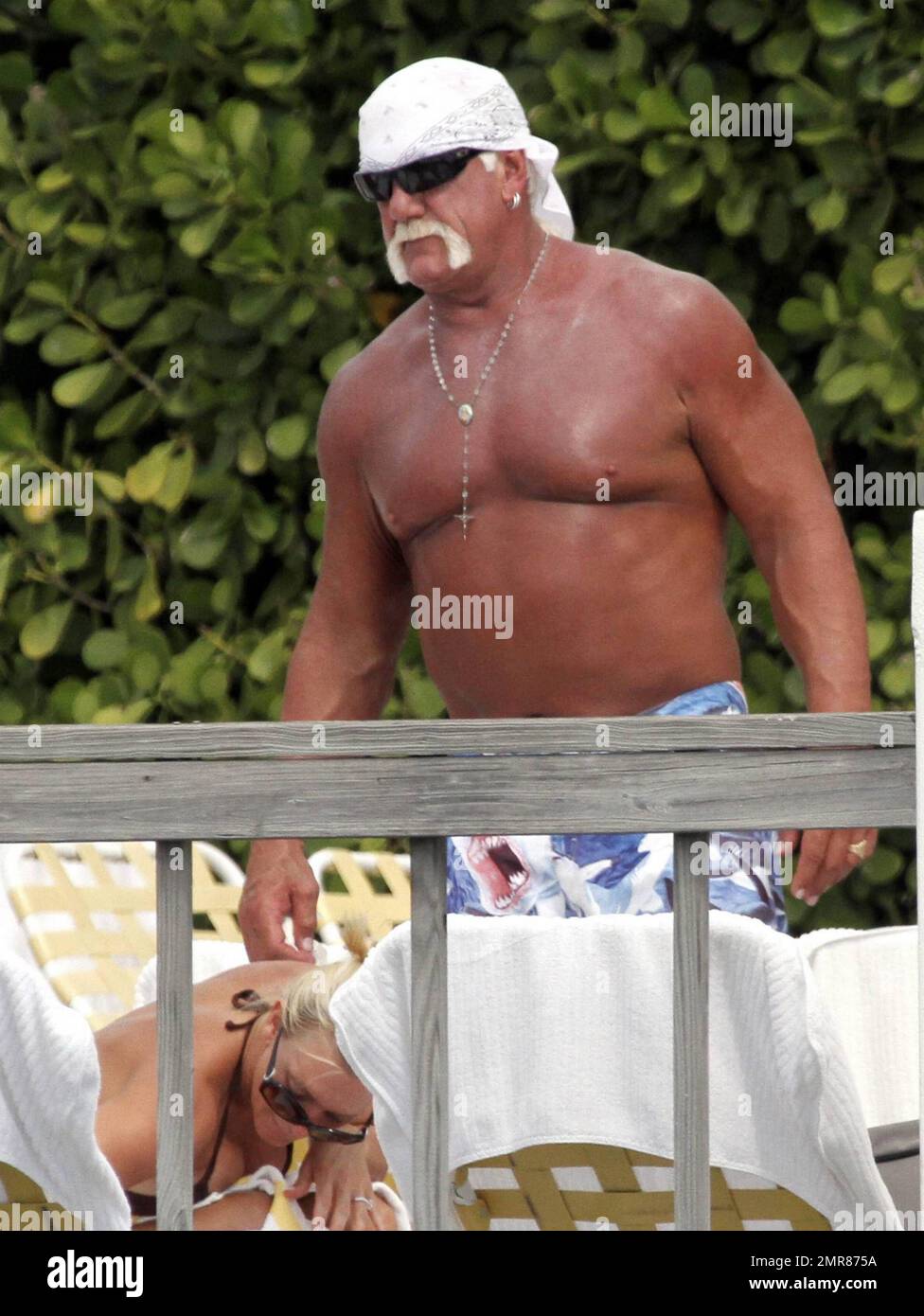 EXCLUSIVE!! Hulk Hogan spends the day poolside with his daughter Brooke and girlfriend Jennifer McDaniel. Brooke Celebrated her 22nd birthday 3 days ago. The Trio soaked up the sun and enjoyed a water-front lunch and drinks. Miami, FL. 5/8/10. Stock Photo