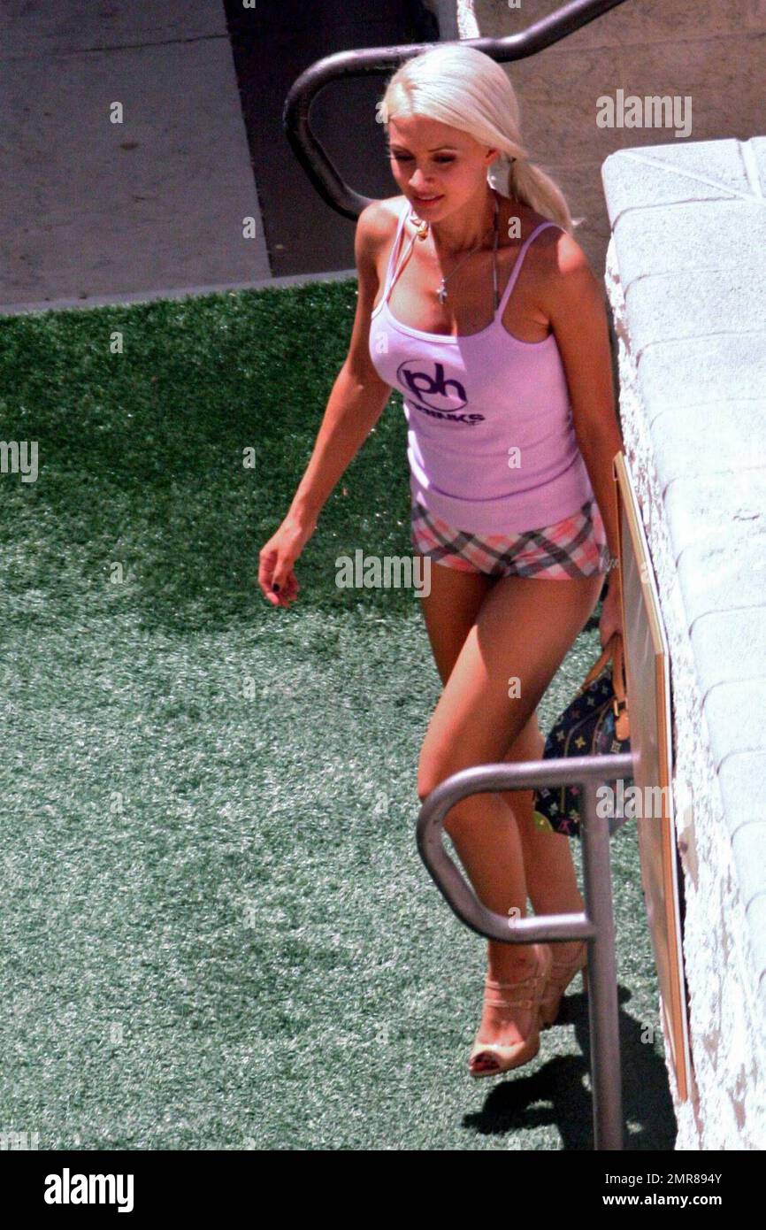 Exclusive!! Holly Madison enjoys some downtime, poolside at her Las Vegas hotel. She enjoyed a cool drink and chatted with fellow pool-goers and even took a moment to examine her belly button while on a break from phone calls. Madison is visiting Las Vegas to attempt the world record bikini parade for the Guinness Book of World Records. Las Vegas, NV. 5/14/09. Stock Photo