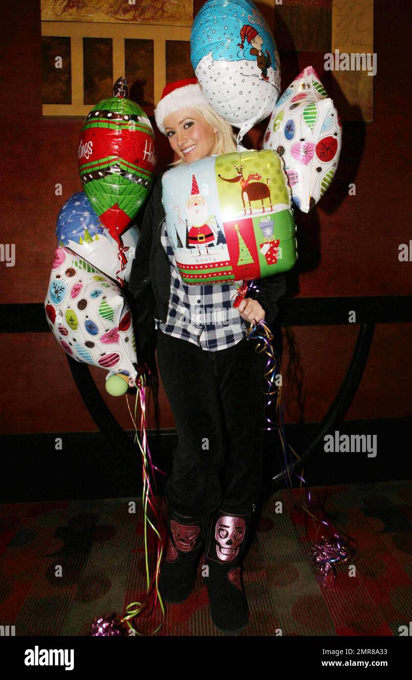 Playboy model, former girlfriend of Hugh Hefner and reality TV star Holly Madison wears a Santa hat and poses with holiday balloons at Platinum Hotel to promote the Holly Jolly Christmas Toy Drive to benefit Toys For Tots. Las Vegas, NV. 12/17/10. Stock Photo