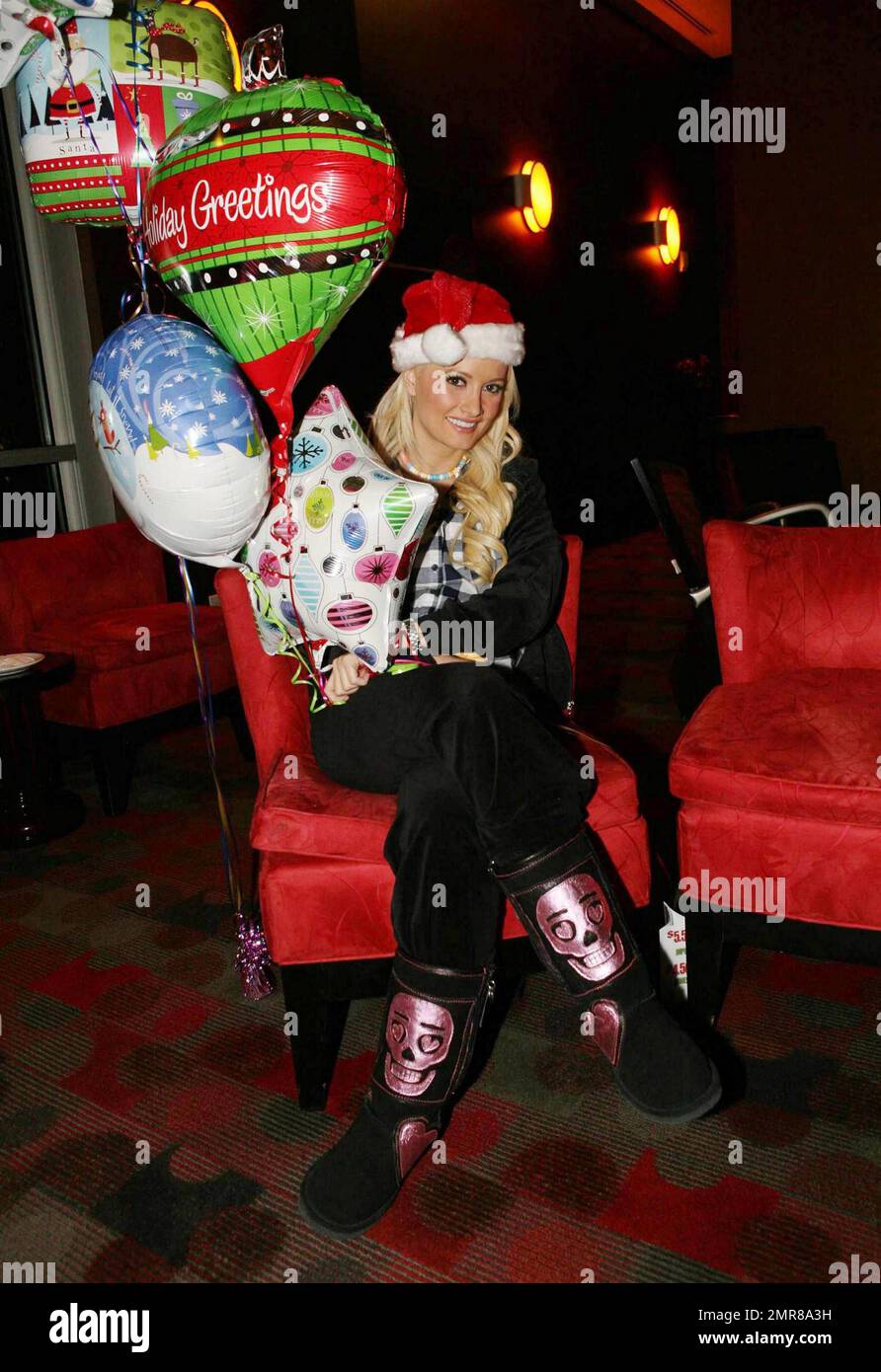 Playboy model, former girlfriend of Hugh Hefner and reality TV star Holly Madison wears a Santa hat and poses with holiday balloons at Platinum Hotel to promote the Holly Jolly Christmas Toy Drive to benefit Toys For Tots. Las Vegas, NV. 12/17/10. Stock Photo