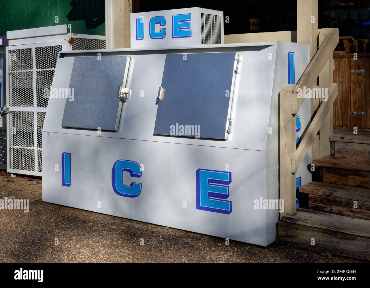 A big double door ice box outside of a store at a campground on a sunny