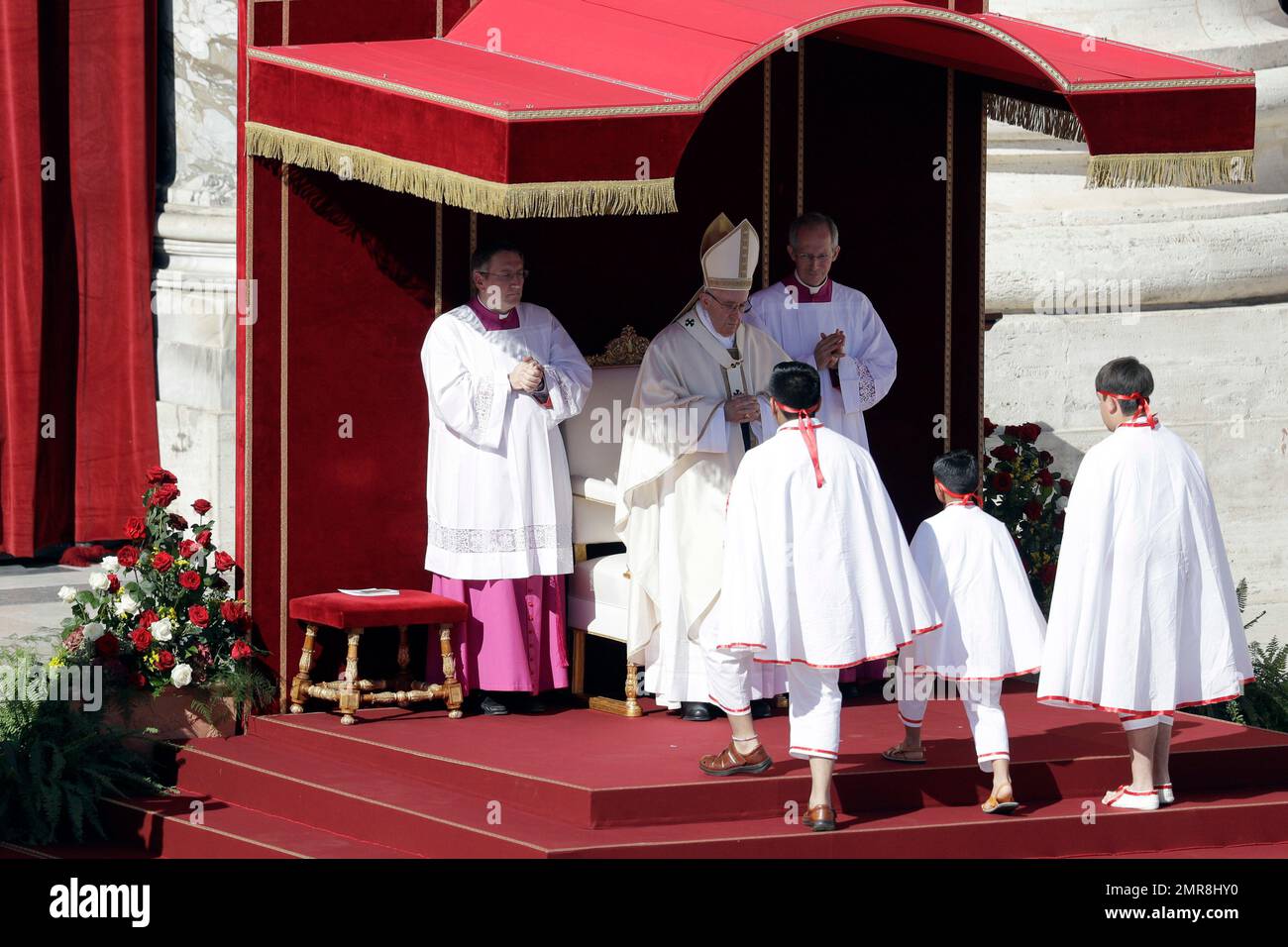 Pope Francis, background center, celebrates a canonization mass in St