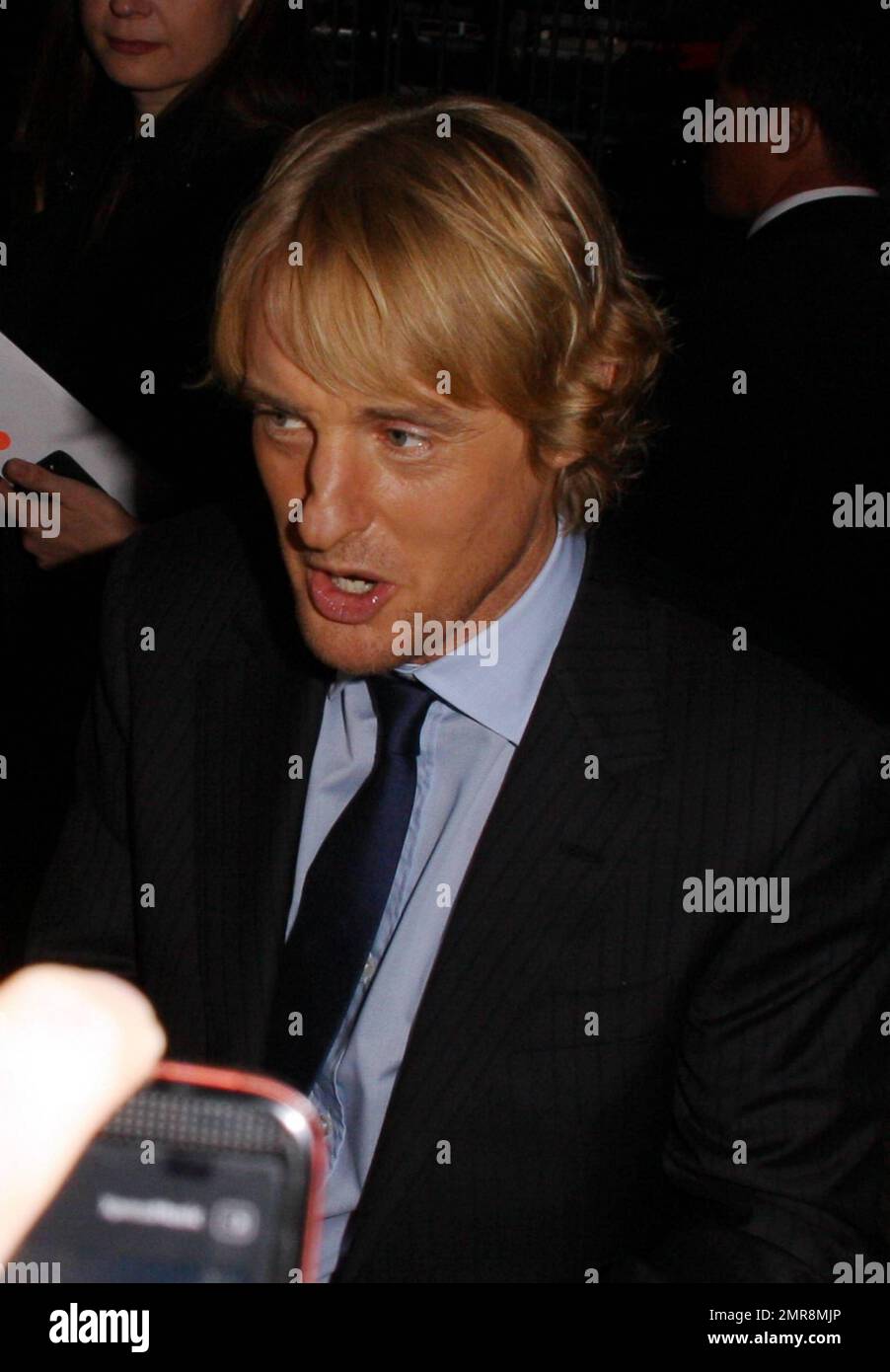 Owen Wilson signs autographs outside the Regency Village Theater at the