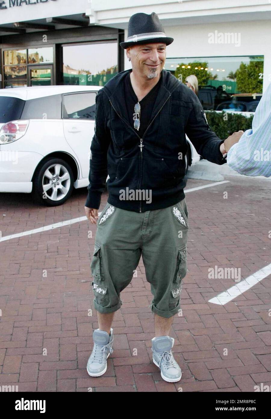 Comedian, TV personality and self-professed germaphobe Howie Mandel gets out of his mini red Smart car and signs an autograph before dining at Nobu Restaurant. Los Angeles, CA. 07/03/10. Stock Photo