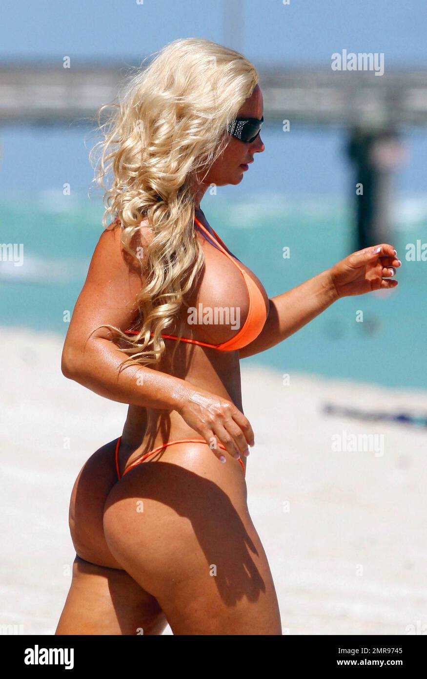 Actor and rapper Ice-T relaxes on Miamis South Beach with wife Coco, who wore a very revealing bright orange string bikini hq image
