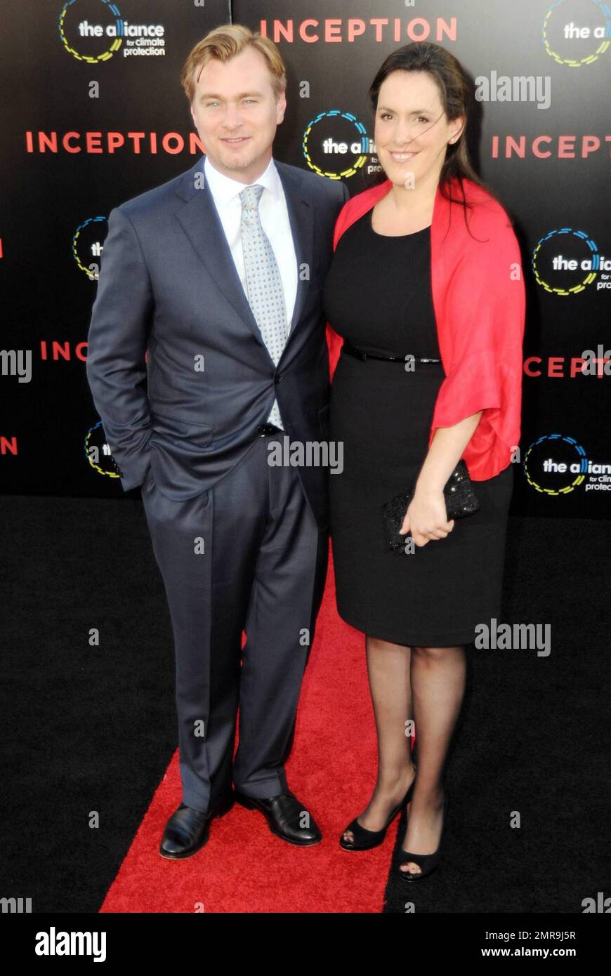 Director Christopher Nolan and his wife Emma Thomas walk the red carpet ...