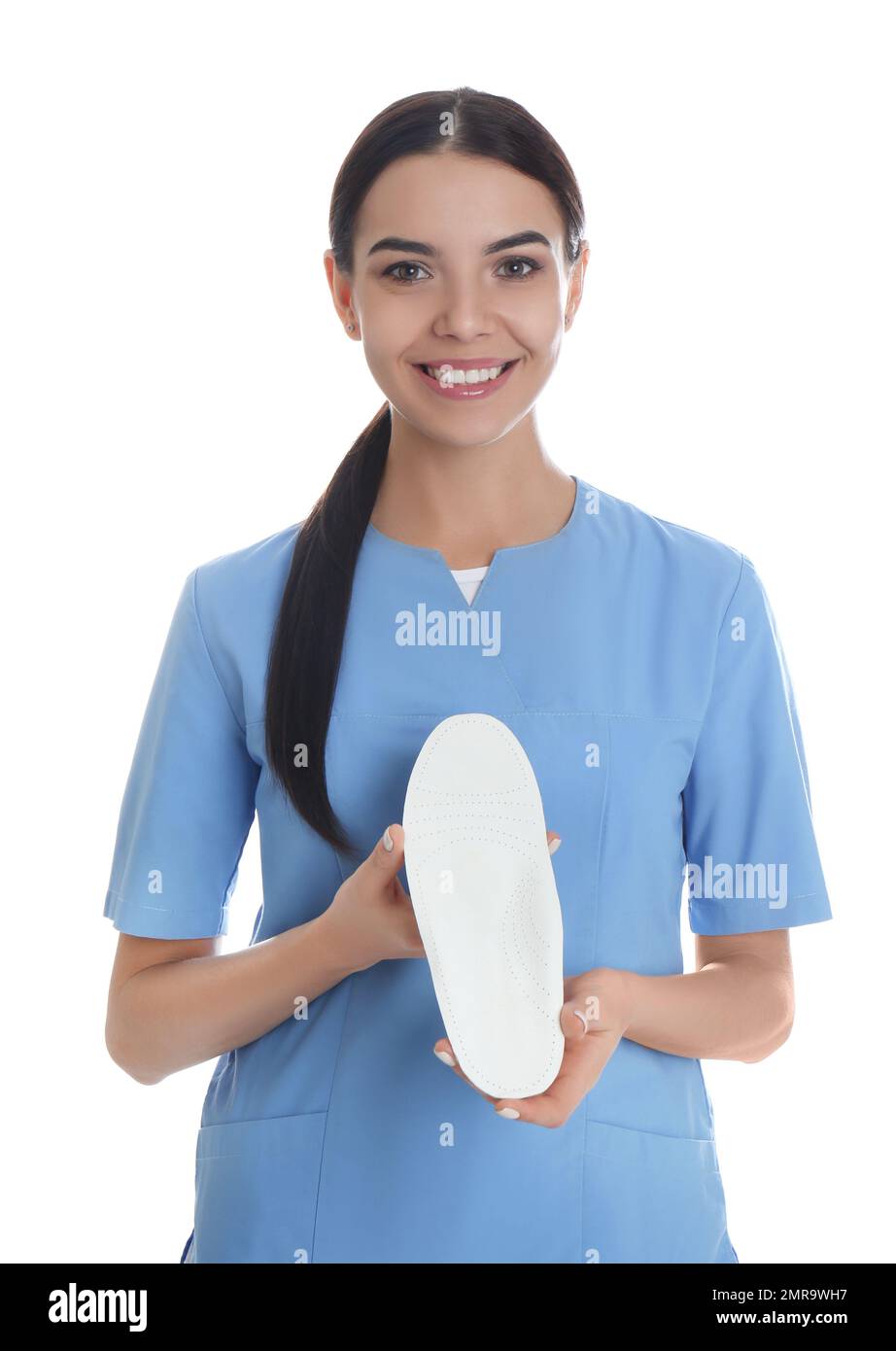 Female orthopedist showing insole on white background Stock Photo - Alamy