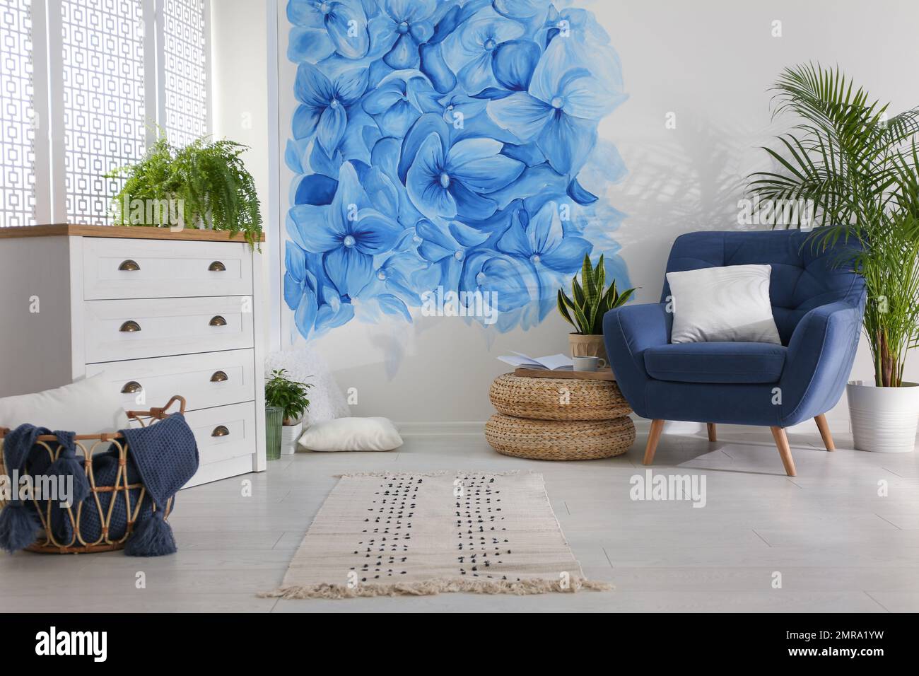 Stylish living room with blue flowers painted on wall. Floral pattern ...