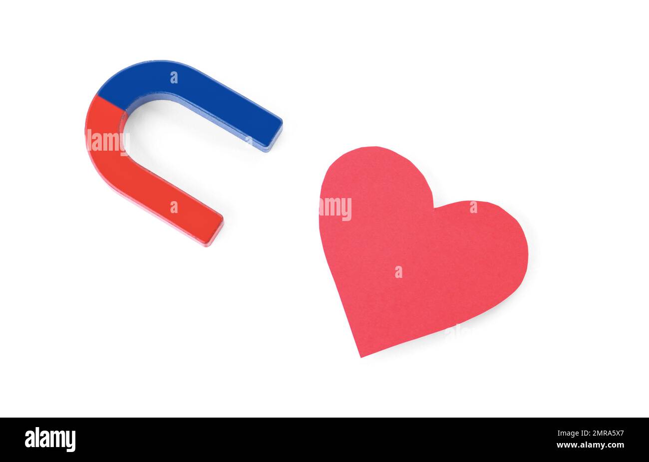 Red and blue horseshoe magnet and paper heart on white background, top view Stock Photo