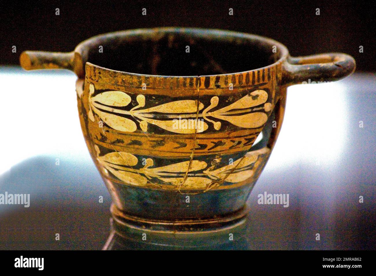 A scyphos is the name given to an ancient Greek drinking bowl with a low foot and two horizontal handles, Museo Archeologico Patroni in Pula, Sardinia Stock Photo